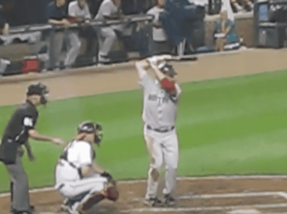 Kevin Youkilis demonstrates his unconventional batting stance, showcasing that form isn't everything in baseball.